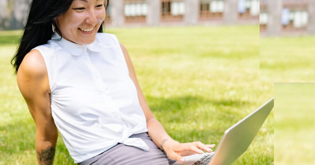 a person relaxing on the grass working her affiliate marketing business
